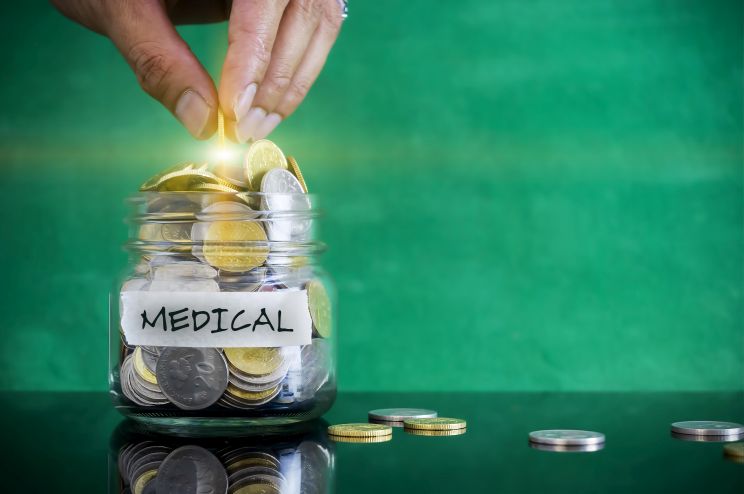 A jar with coins for health spending accounts